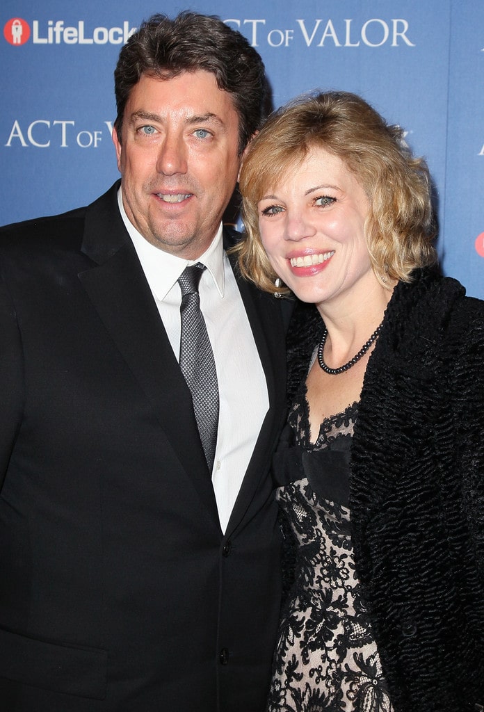 Photo of Lydia Hurlbut wearing a black top and outer and Shane Hurlbut in a black coat with a white shirt and black tie.